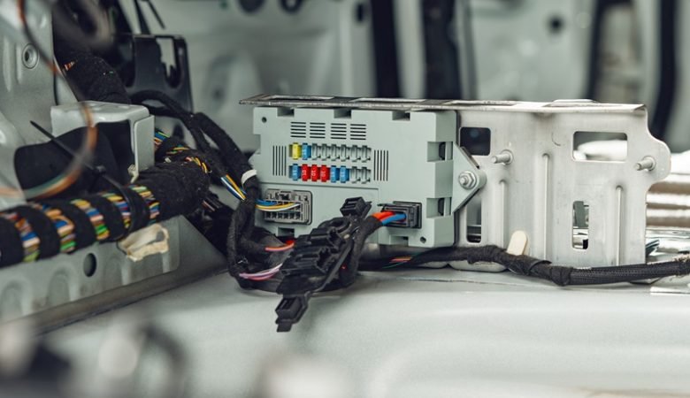 Where do fiber optics fit into automotive wiring harnesses?